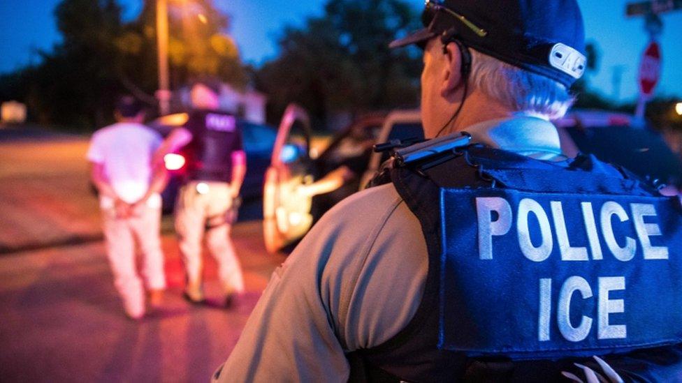 US Immigration and Customs Enforcement officers carry out a raid in Sherman, Texas, in June