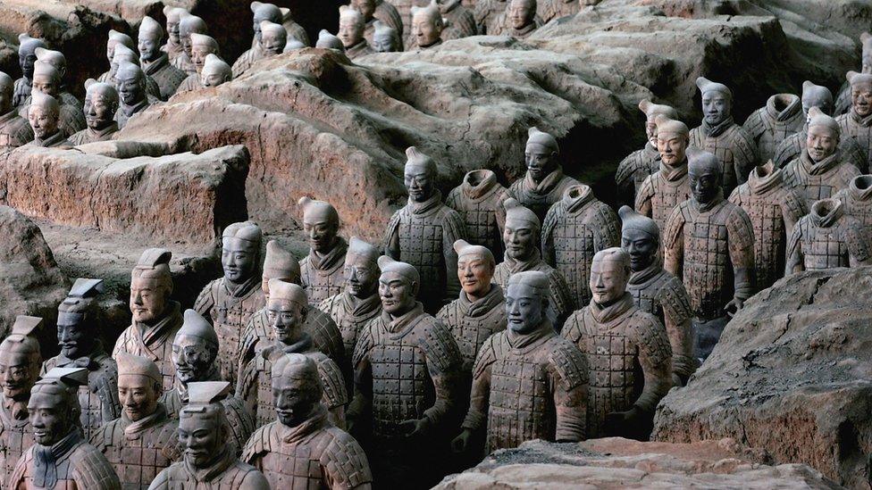 Ancient terracotta warriors stand in a pit at the Emperor Qin's Terracotta Warriors and Horses Museum on July 7, 2006