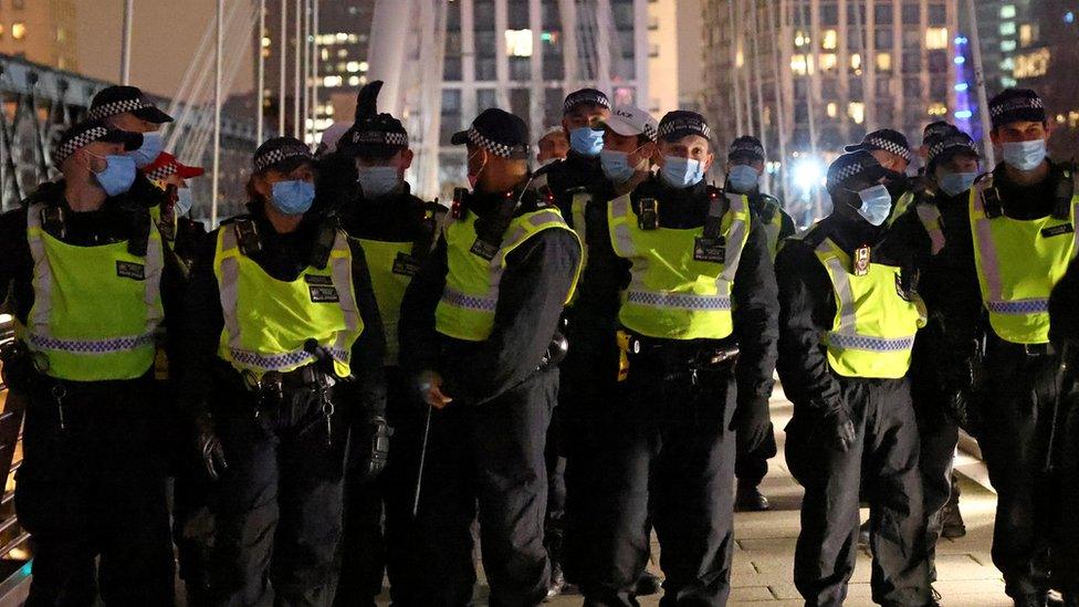 Police at an anti-lockdown protest in London on 1 January