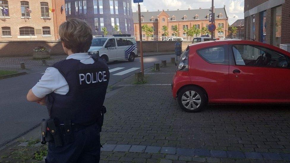 police officer standing guard close to a police building in the southern Belgian city of Charleroi following a machete attack, August 6, 2016