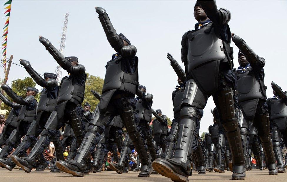 Burkina Faso's anti-riot police officers parade during celebrations marking Burkina Faso's 55th anniversary of independence from France on December 11, 2015