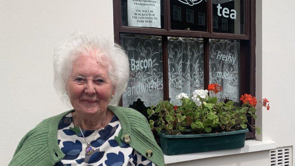 Chairperson Caroline Lewis smiling outside the Market Square café in Pontypool