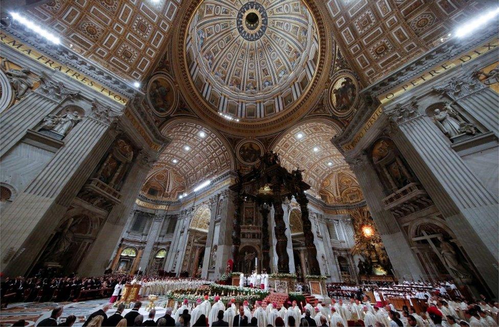 A picture of Mass on Holy Saturday highlighting the spectacular ceilings of Saint Peter's Basilica in the Vatican