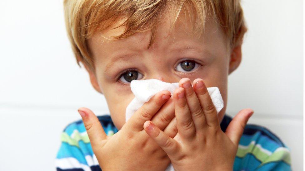 boy blowing his nose