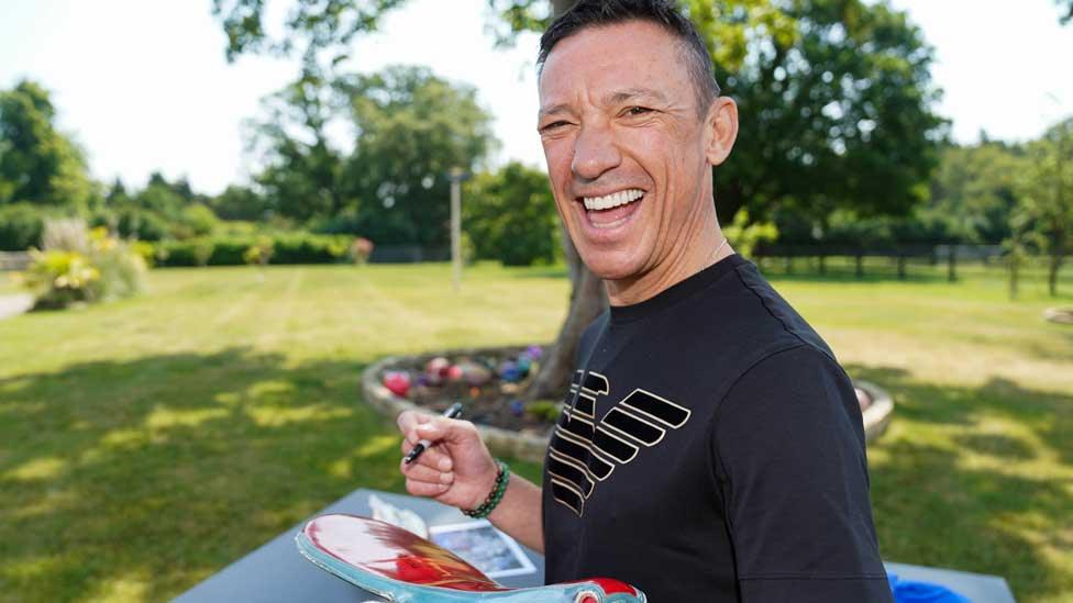 Frankie Dettori signs a saddle