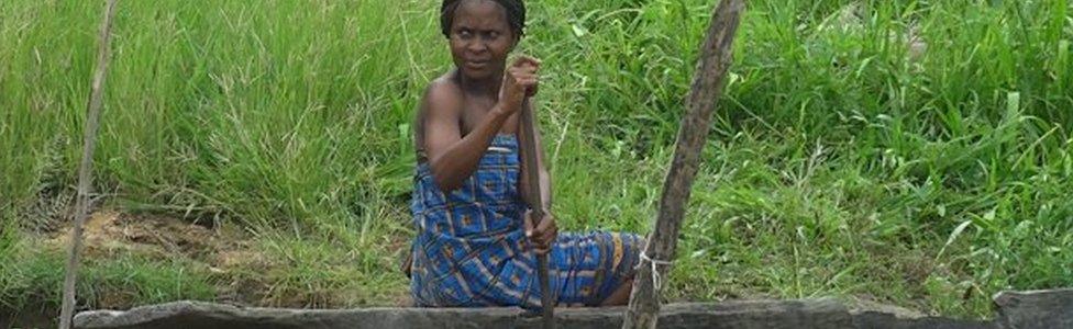 A woman in a canoe in the Niger Delta