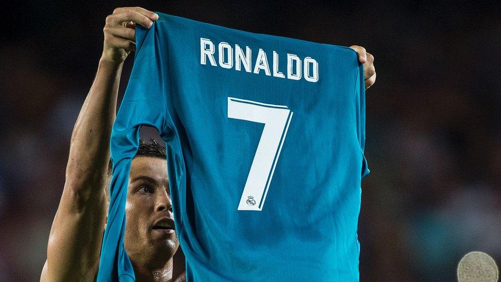 Ronaldo holds up shirt