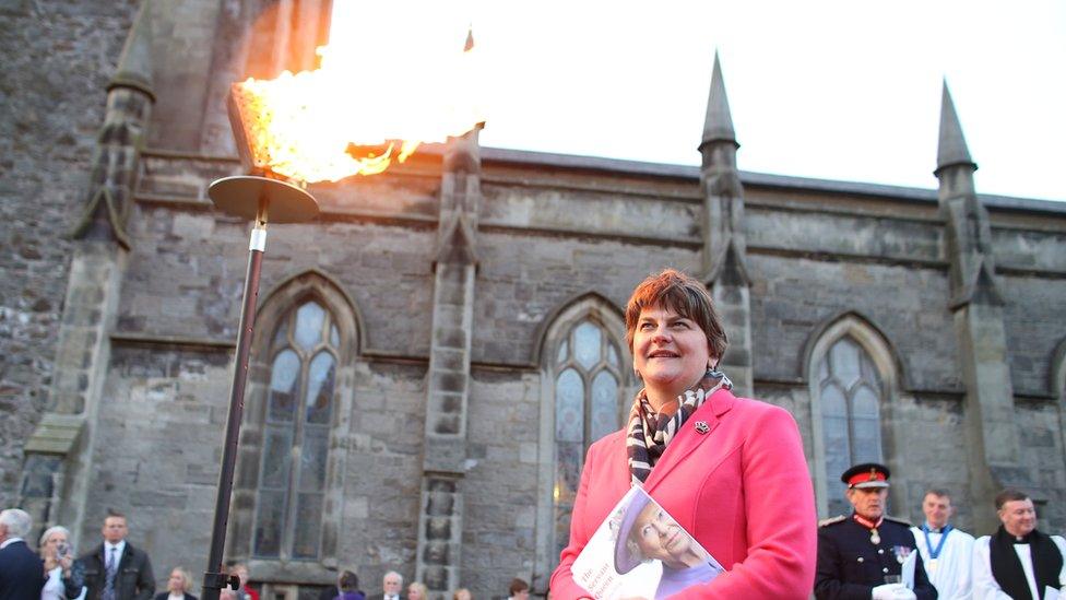 Northern Ireland First Minister Arlene Foster looks at a beacon lit outside St Macartin's Cathedral in Enniskillen