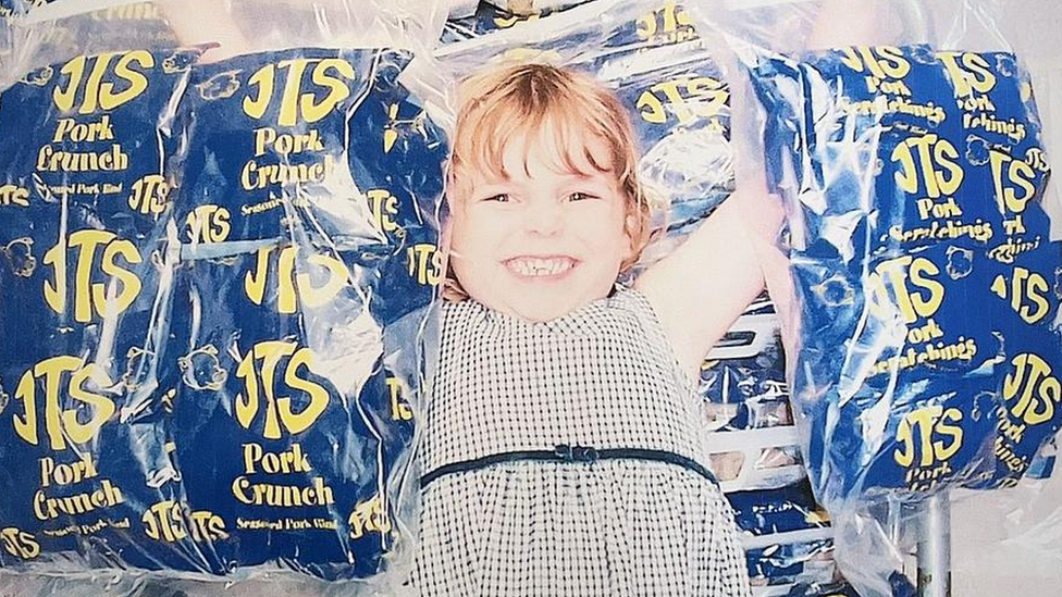 Madeleine Hann holding bags of snacks