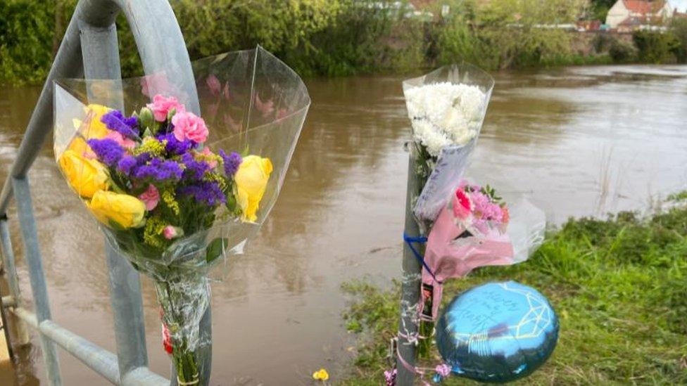 Flowers and balloons by the rover bank in Malton