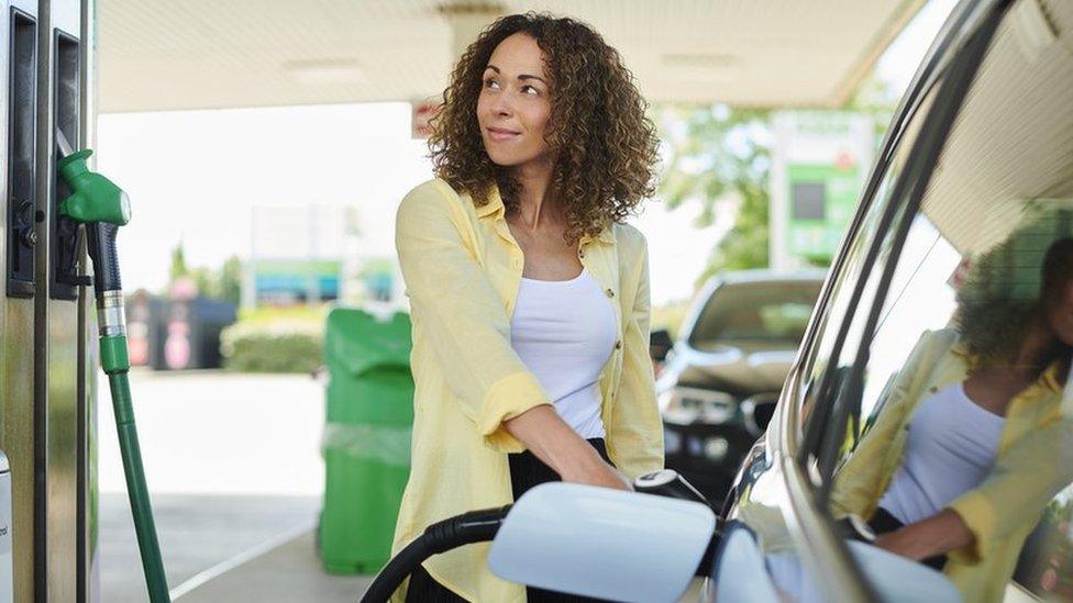 Woman filling car