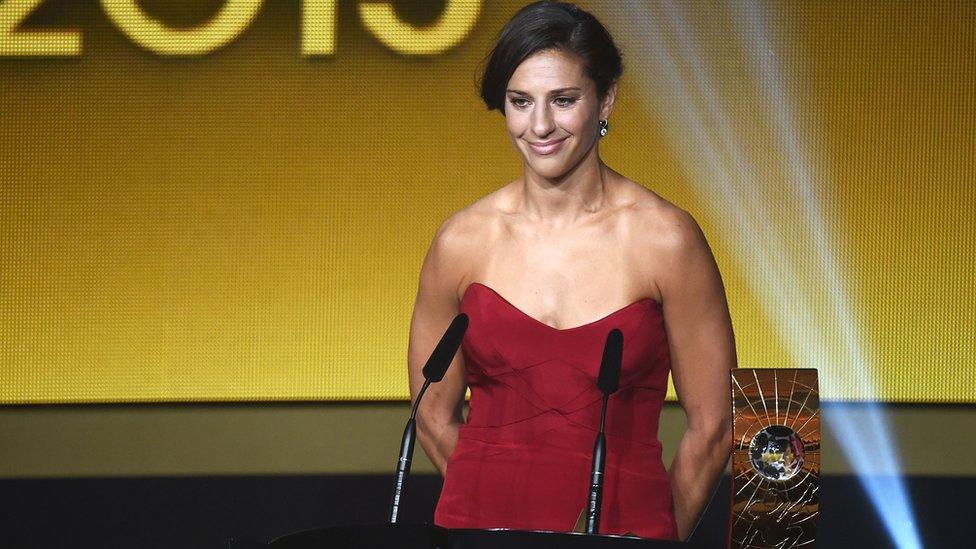 Carli Lloyd poses with the Women's World Player of the Year award