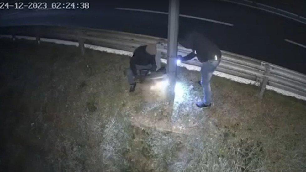 Two men cut down a speed camera