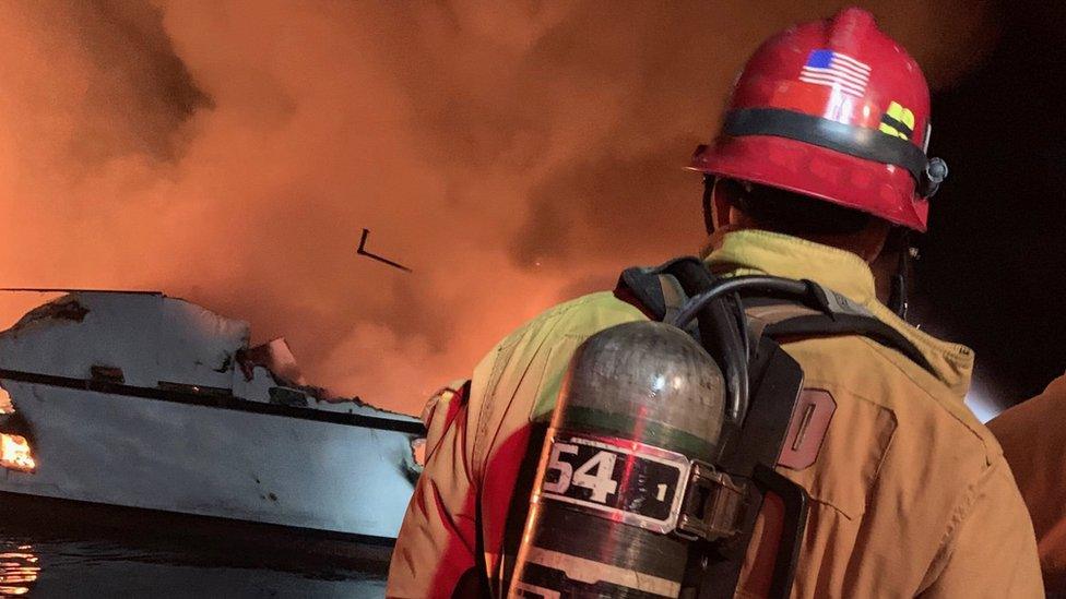 A firefighter attempting to put the fire out