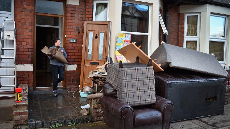 Woman clearing flooded home