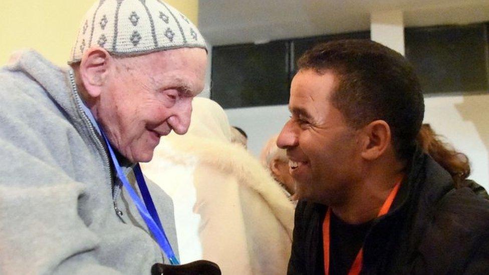 Jean-Pierre Schumacher (L), the last survivor of the monks hostage taking, at the ceremony