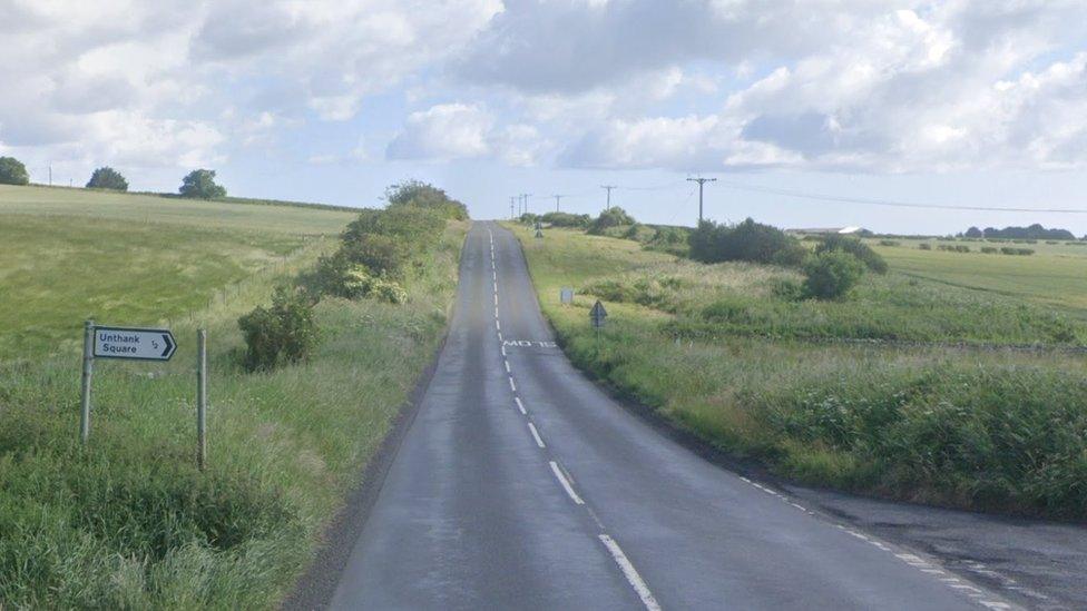 A road with a sign to Unthank Square