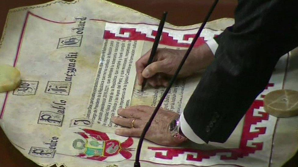 Pedro Pablo Kuczynski signs a certificate which formalised the presidency