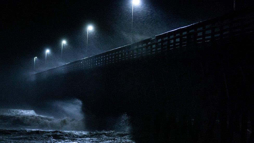 Waves crash into the Second Avenue Pier in Myrtle Beach, South Carolina on September 14, 2018.