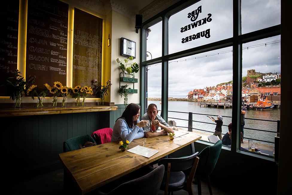 Emma Morley and Lee Clarke from Peterborough, drinking at The Moon and Sixpence, Whitby. 4 July 2020