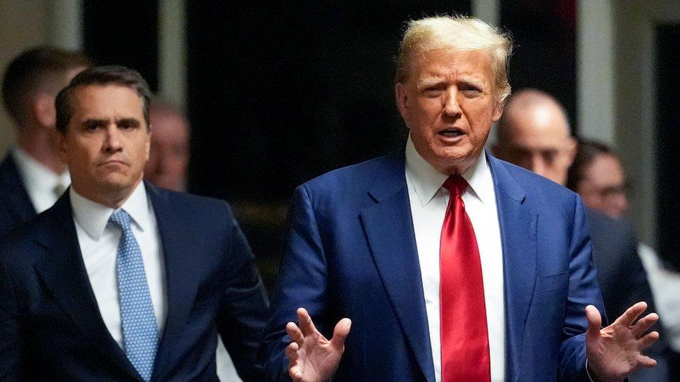 Donald Trump speaks outside a hearing in his New York criminal case on 25 March.