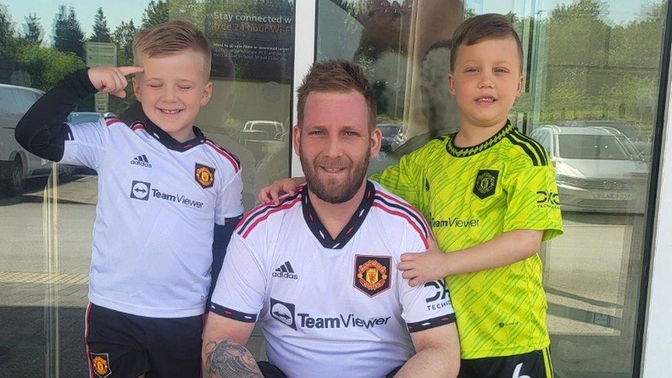 Quinn Lamerton (left), Jamie Lamerton (centre) and Jayden Lamerton (right) in Manchester United kits