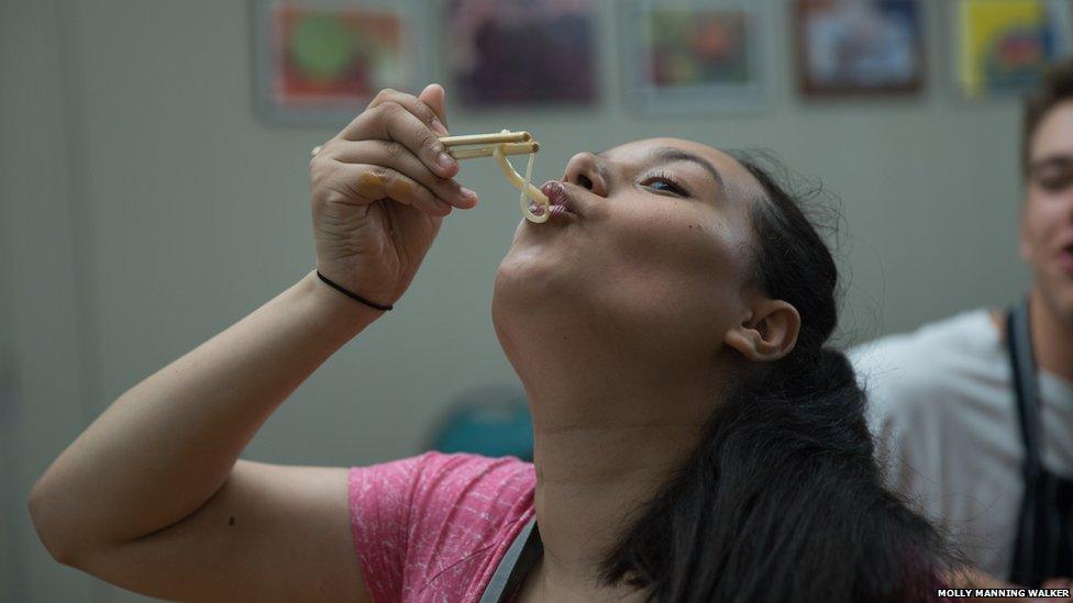 Mia sampling her noodles