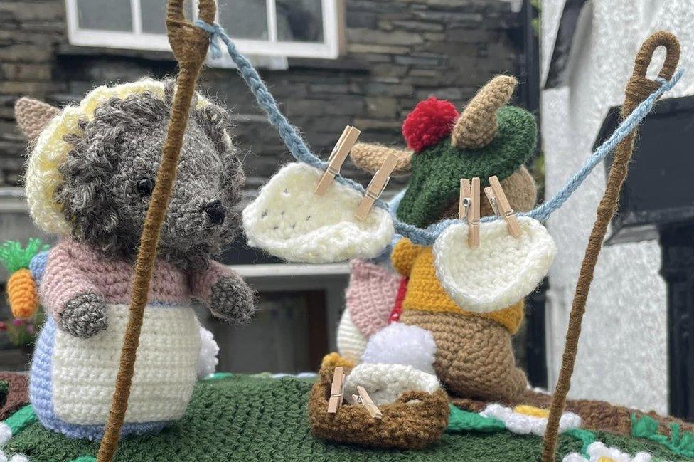 Close up of hedgehog and rabbit toy with crocheted washing line