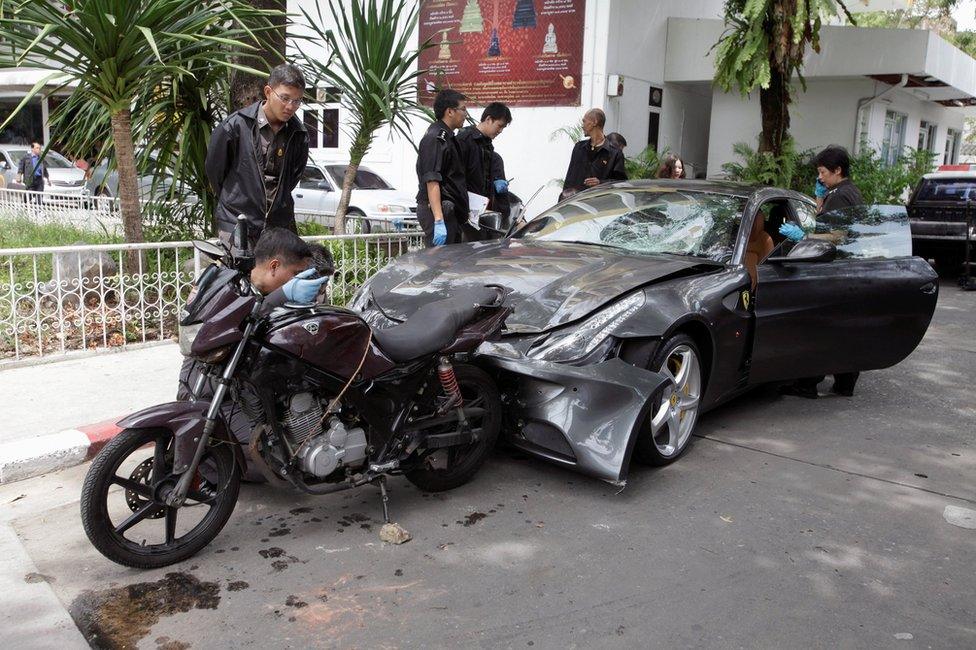 Policemen examine a damaged Ferrari at the home of the late Red Bull founder Chaleo Yoovidhaya in Bangkok, Thailand 3 September 2012.