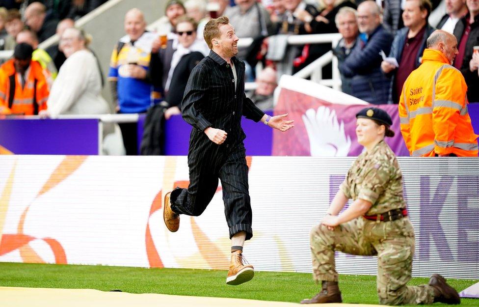 Ricky Wilson of The Kaiser Chiefs entertains the crowd during a delay to the Rugby League World Cup group A match at St James' Park, Newcastle