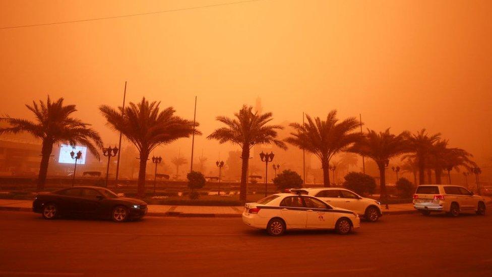 Vehicles drive along a road during a severe dust storm in Iraq's capital Baghdad