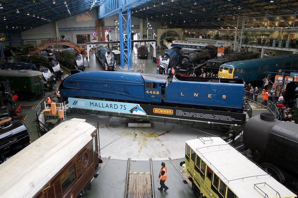 Visitors look on at the steam locomotives on display at the National Railway Museum on July 3, 2013 in York