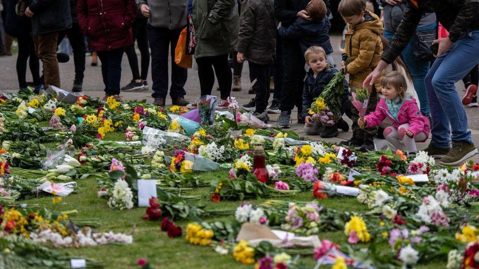 People leave flowers and tributes to Prince Philip at Windsor Castle