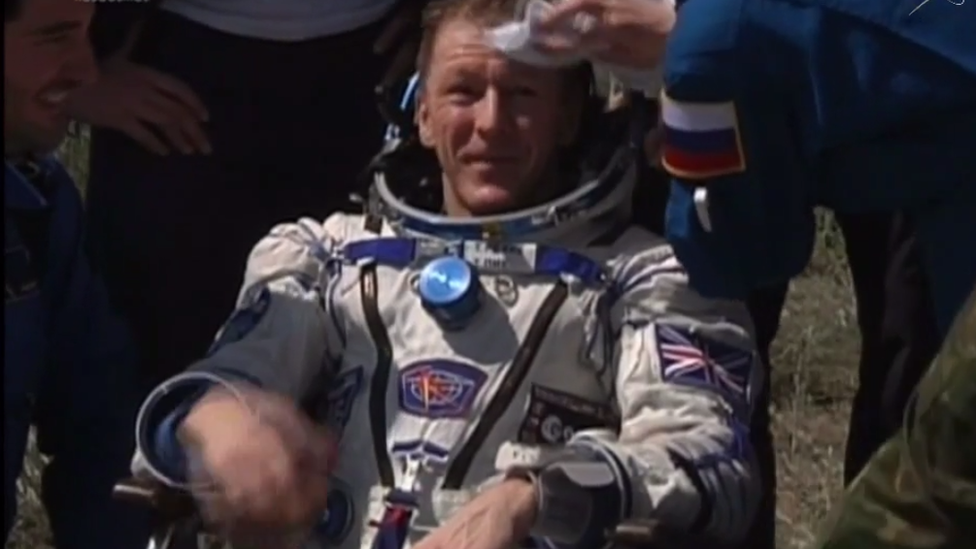 Tim Peake having his brow wiped