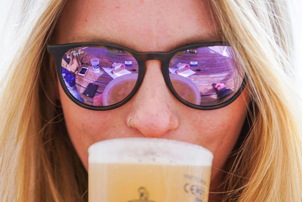 A woman drinks a pint