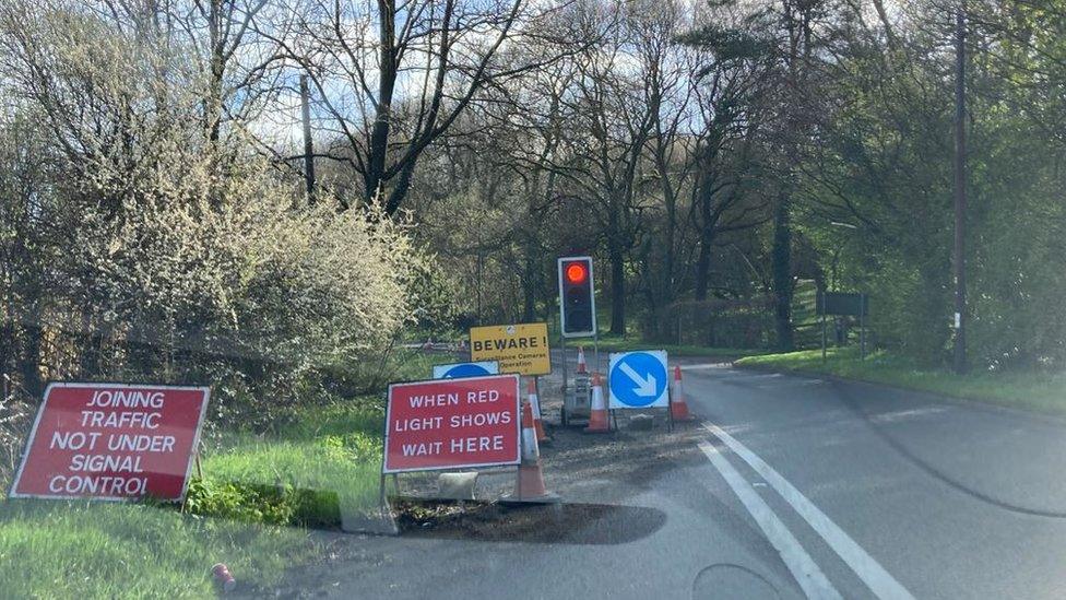 temporary traffic lights and road signs on the road