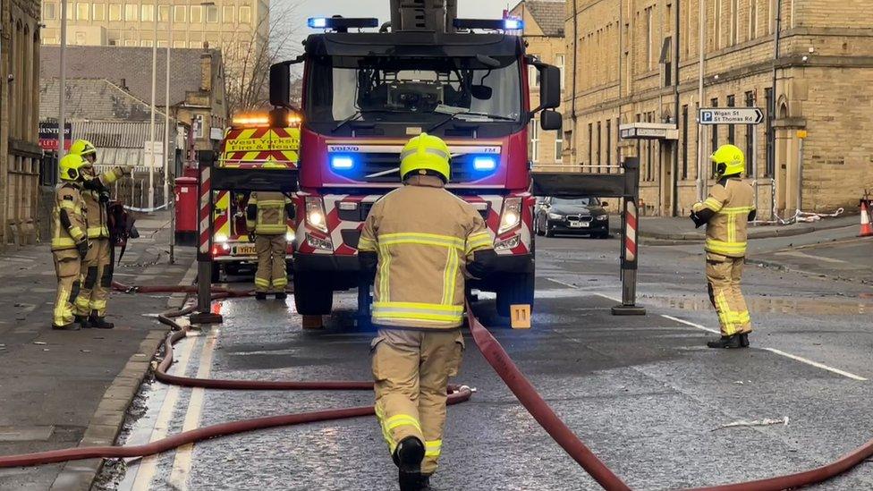 Firefighters in front of a fire engine