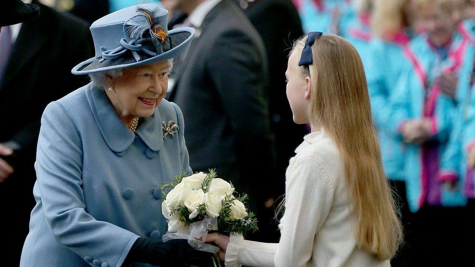 The Queen receiving a posy from an 11-year-old girl