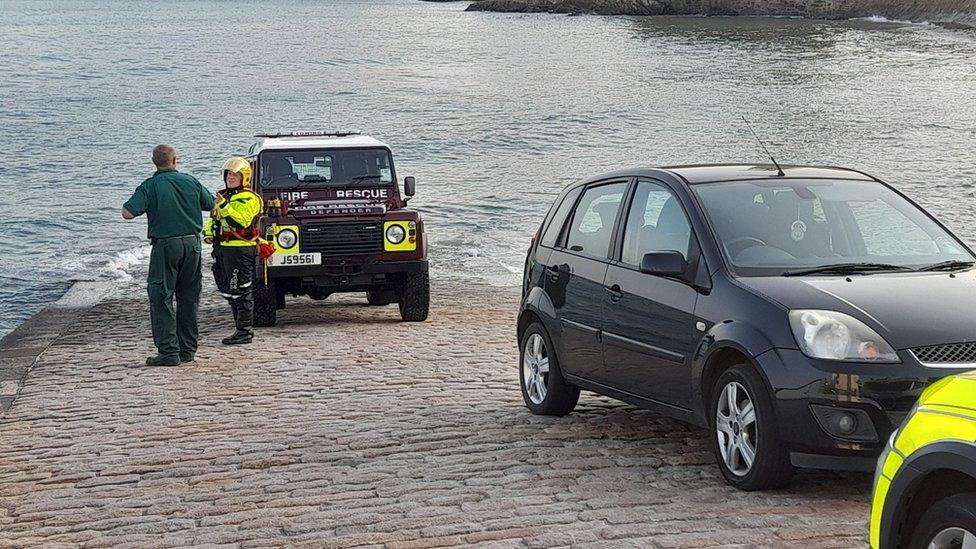 Fire and rescue services talking on slipway