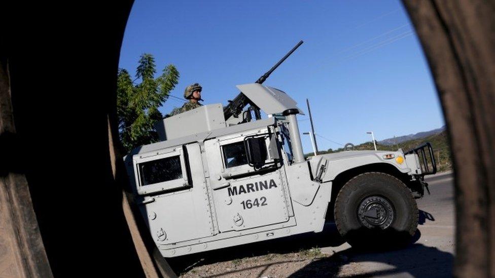 Soldier mans his machine gun atop an armored vehicle in a checkpoint at the hometown of Joaquin "El Chapo" Guzman in the municipality of Badiraguato