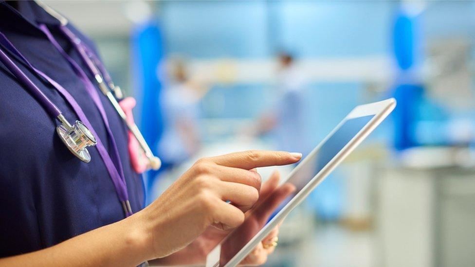 Nurse with tablet computer
