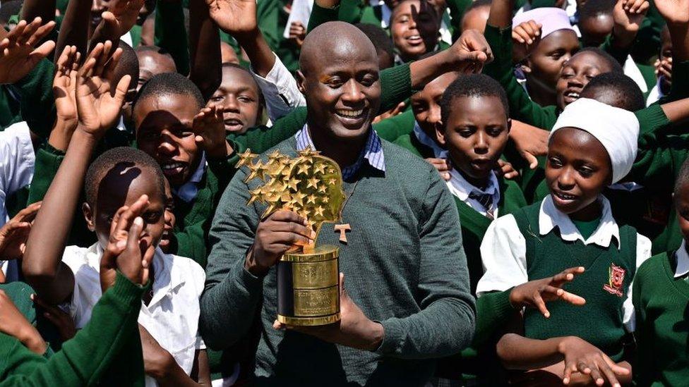 Peter Tabichi with pupils and his award