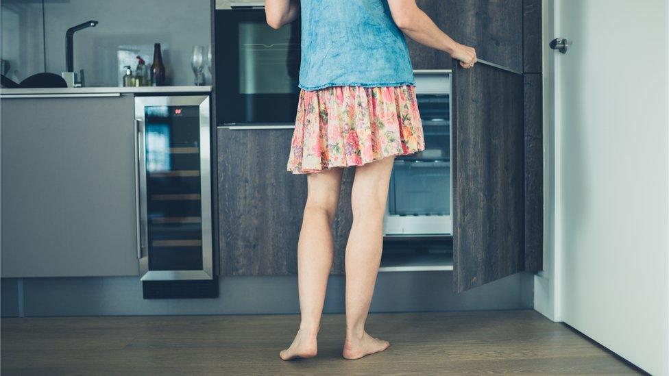 Woman opening a freezer