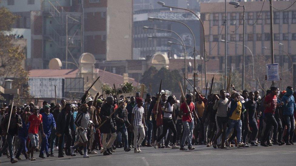 A supporter of ex President Jacob Zuma during ongoing violent clashes in downtown Johannesburg, South Africa, 11 July 2021.