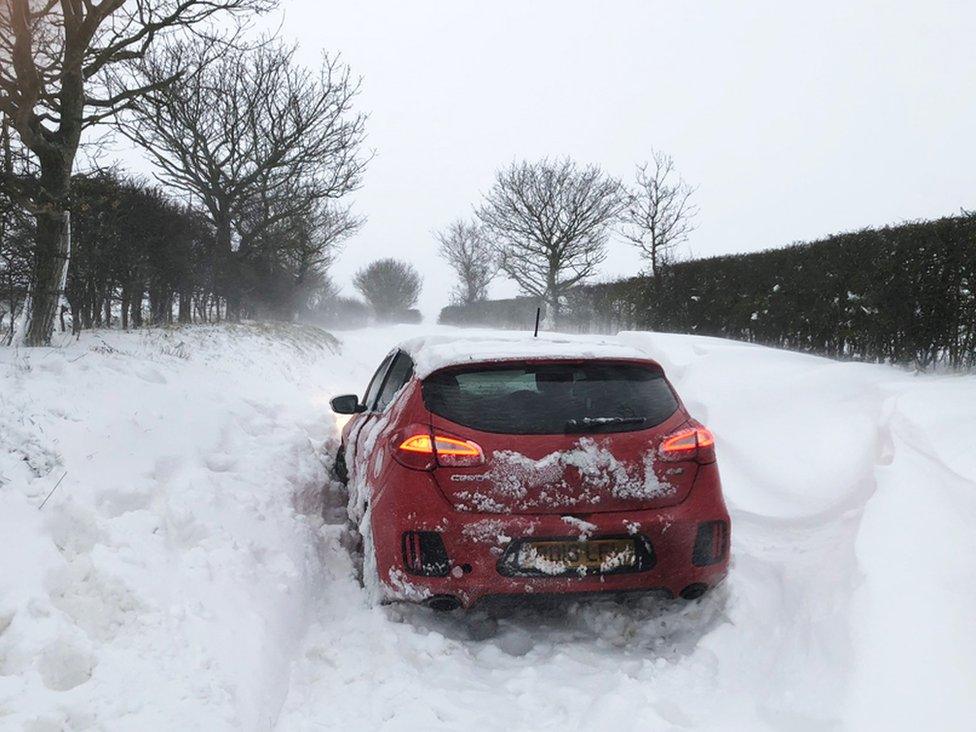 Handout photo of a car stuck in the snow at Southrepps in Norfolk, on 8 February 2021