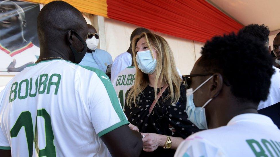 Marion Diop, the widow of former international Papa Bouba Diop is comforted by his former teammates