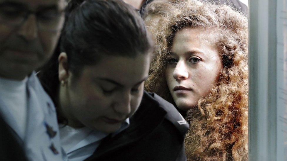 Palestinian teenager Ahed Tamimi enters a military court at Ofer prison, near the West Bank city of Ramallah, on 13 February 2018