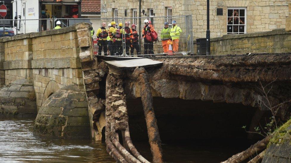 Emergency services by the collapsed bridge in Tadcaster, North Yorkshire