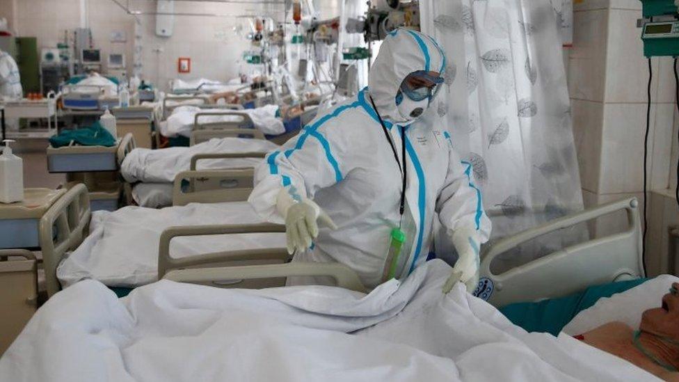 A medical worker treats a patients in a hospital in Moscow, Russia. Photo: 25 May 2020