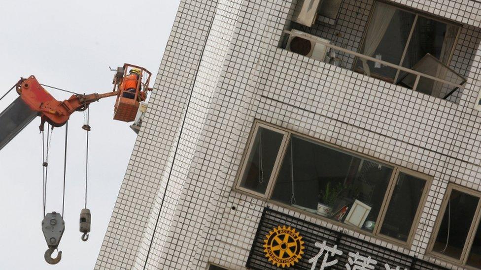 rescue worker inspects building